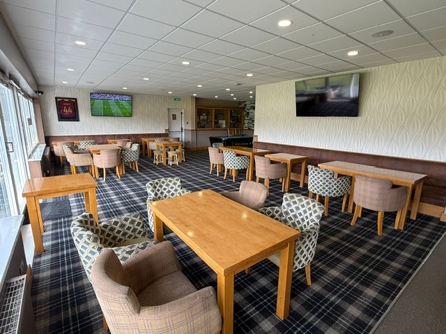 Seating, tables and sports screens in the Tom Clish Lounge